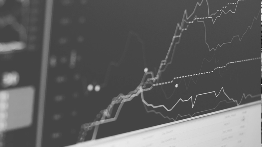 Monochrome image of a stock market graph on a computer screen, showcasing financial data trends.