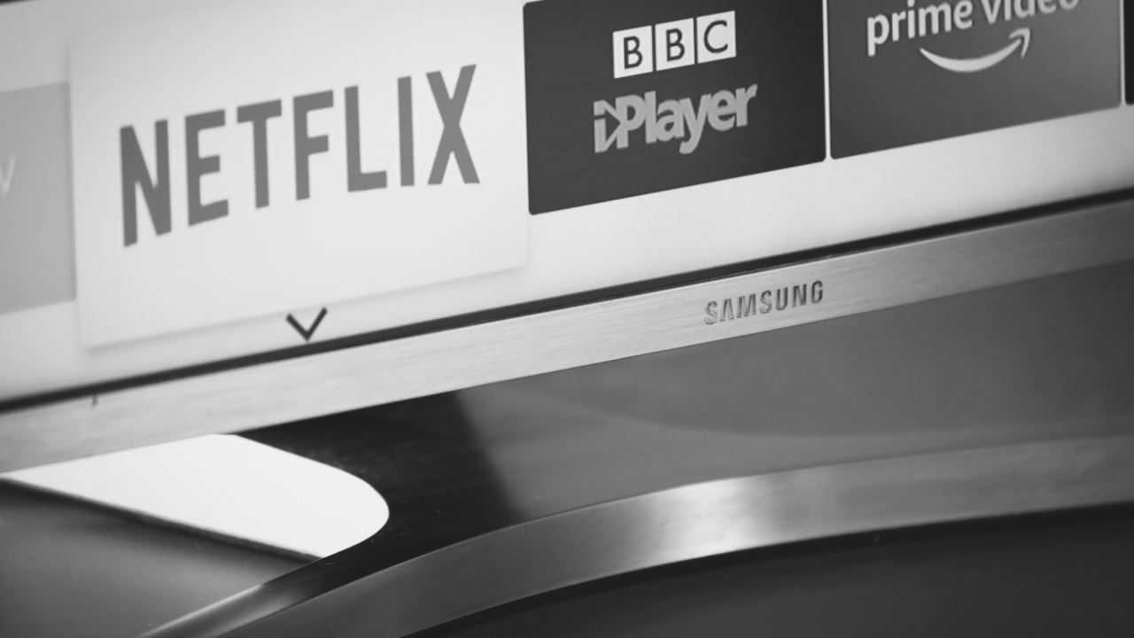 Close-up of a Samsung TV screen displaying streaming service logos: Netflix, BBC iPlayer, and Prime Video.